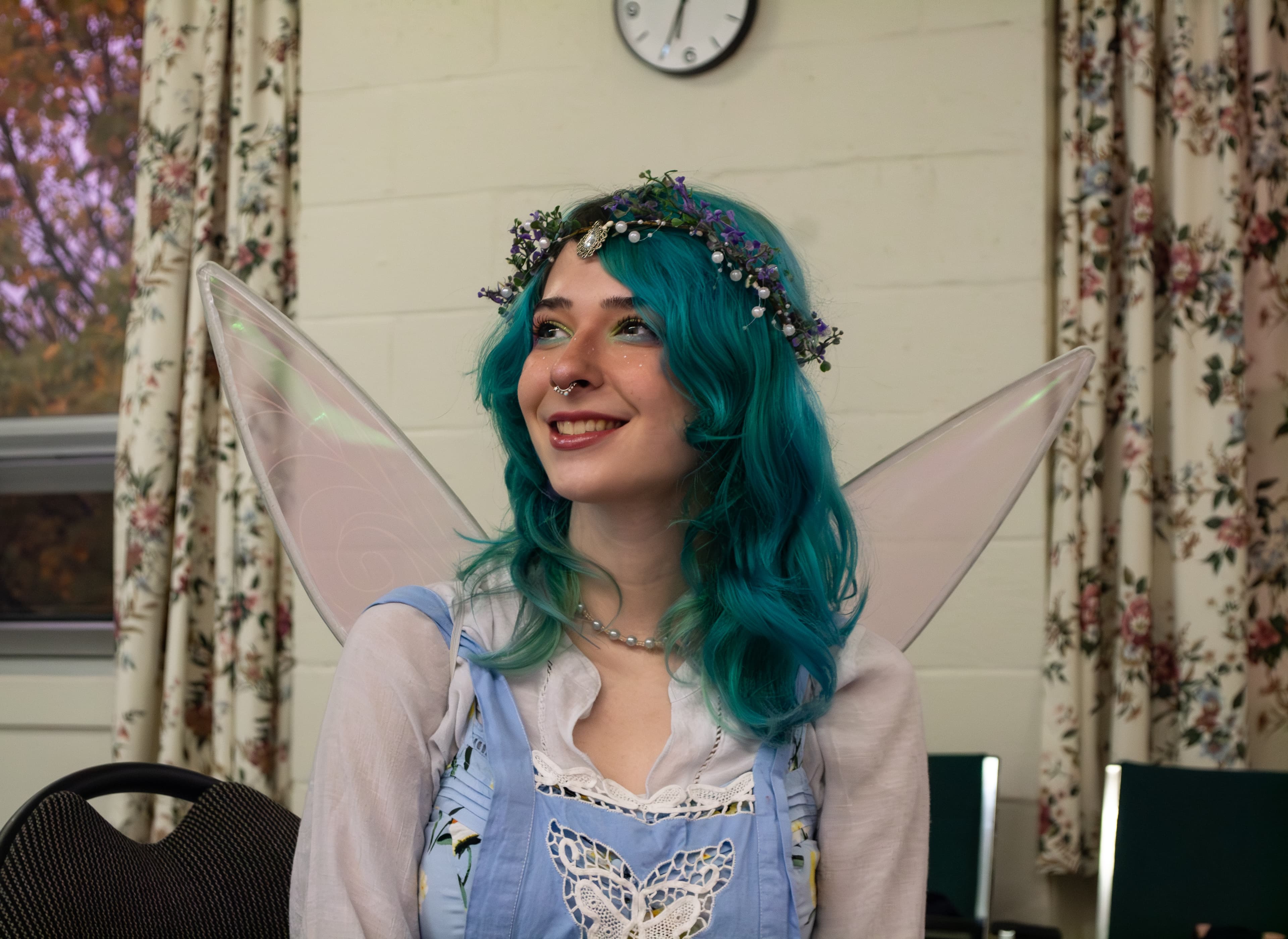 A person wearing a fairy costume smiling.